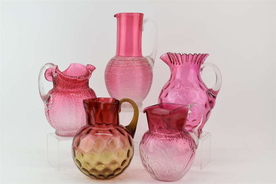 Group of Cranberry Glass Pitchers